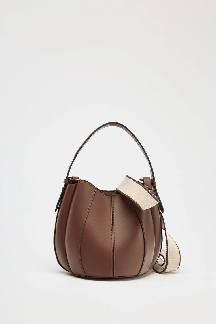 Versatile bucket bag styled as shoulder handbag