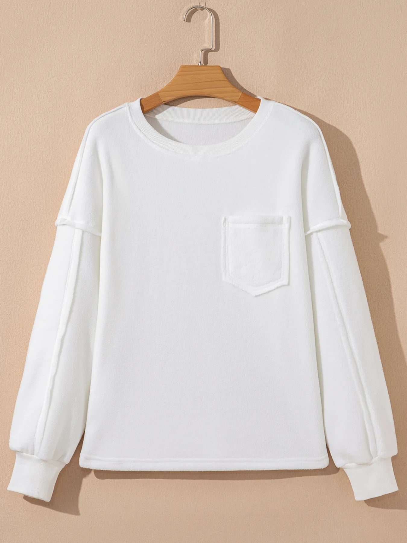 Versatile exposed seam blouse in 100% polyester fabric

