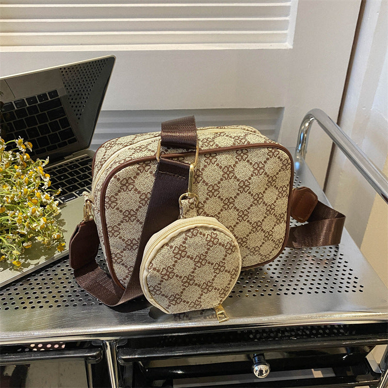 Vintage plaid crossbody set blends comfort and structure; PU builds, square form, zipper closure, matching mini bag included.