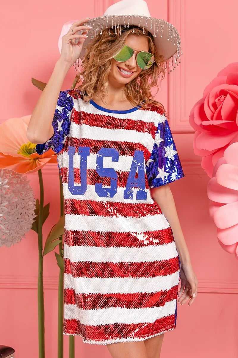 Woman posing by fireworks in BiBi USA flag sequin dress

