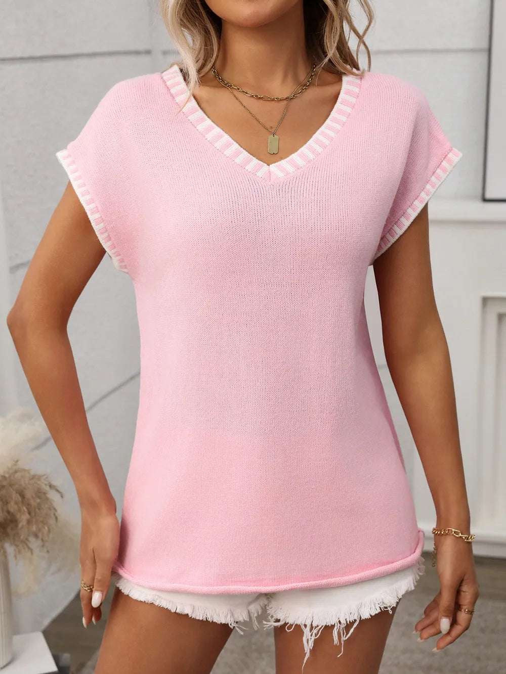 Side angle of contrast knit top showing relaxed silhouette

