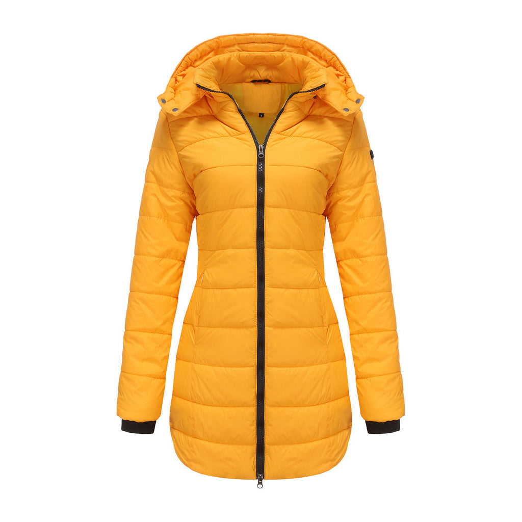 Woman in waterproof cotton-padded jacket standing on a modern city rooftop with skyline view

