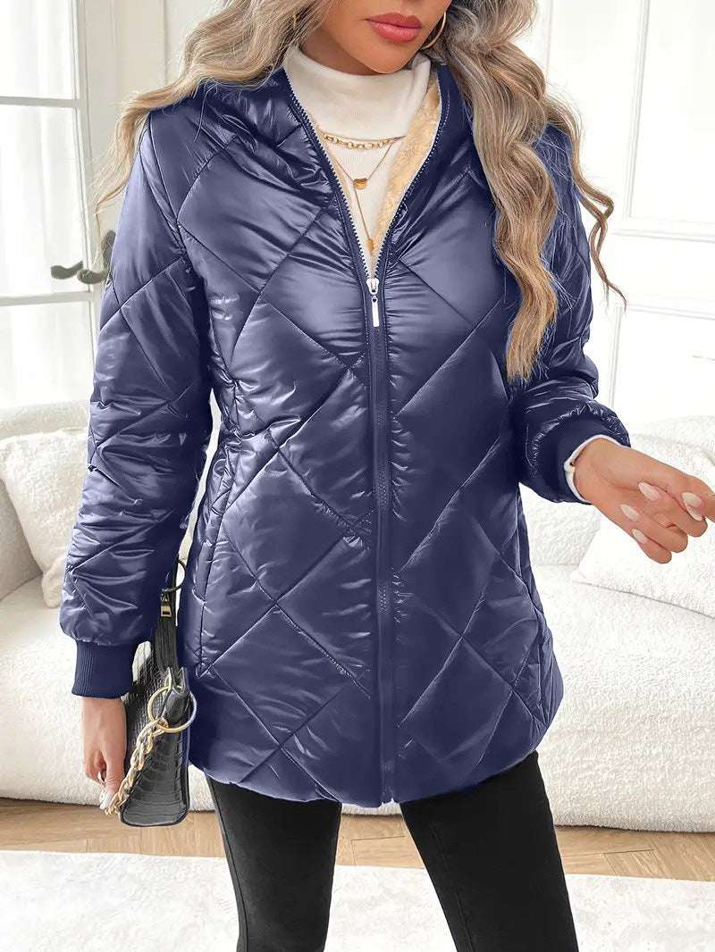 Side profile of black quilted women’s winter coat styled with white turtleneck and belt

