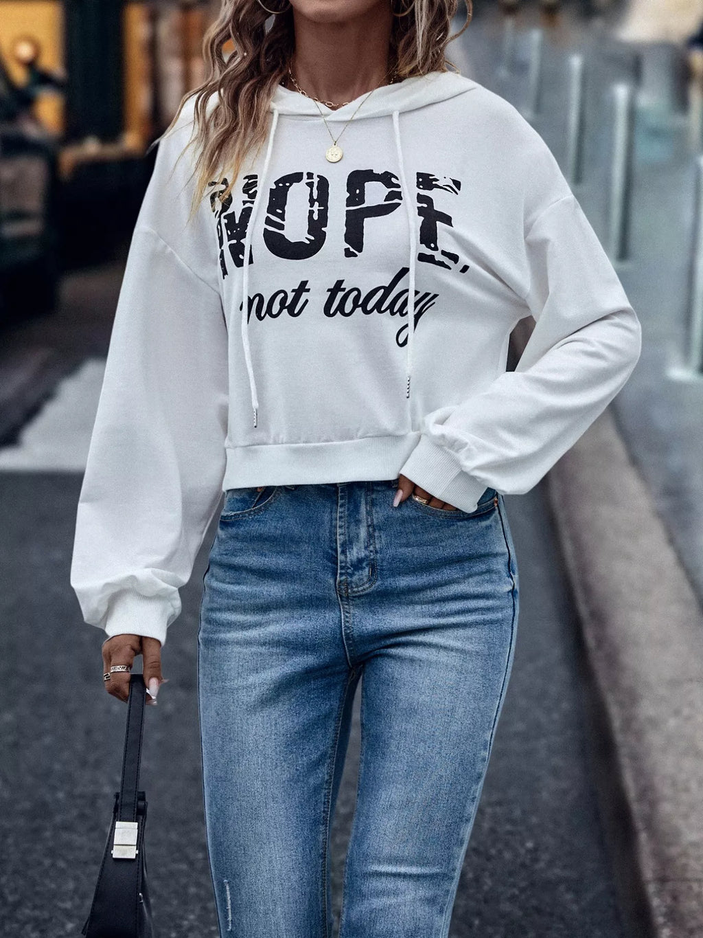 Women’s letter graphic hoodie lifestyle – streetwear look styled with denim