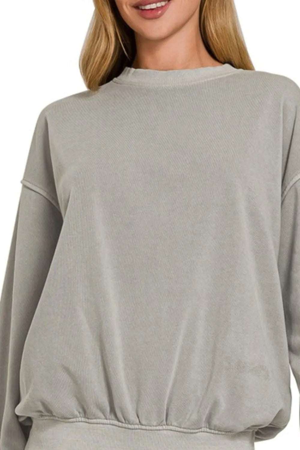 Model lounging in Zenana pigment dye fleece sweatshirt and leggings

