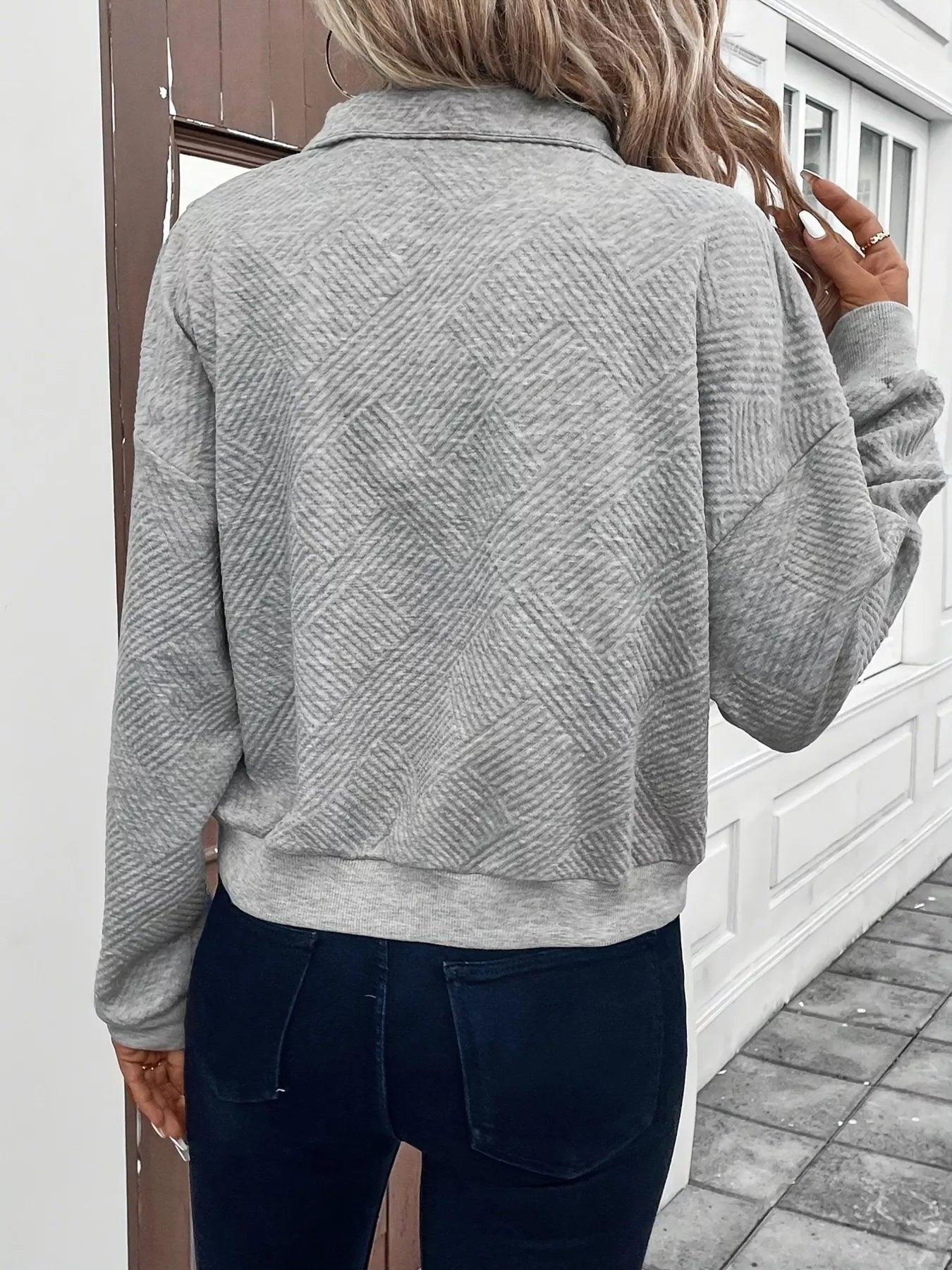 Zipper action shot of textured half zip long sleeve women's sweatshirt, illustrating easy adjustability and no-stretch comfort.
