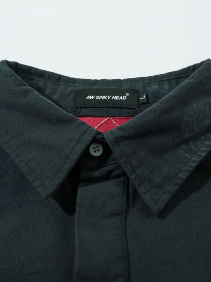Zoom-in on embroidered letter detail on black sweatshirt

