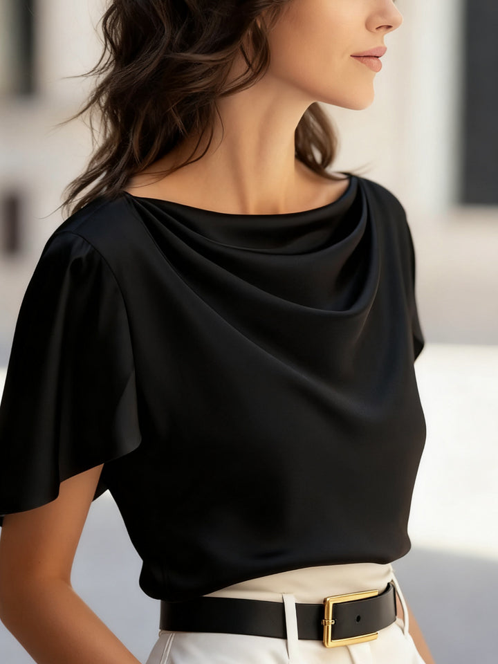 Women wearing black scoop neck casual top paired with high-waist jeans, relaxed weekend look
