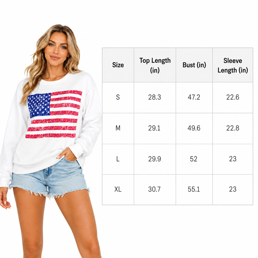 Woman wearing a white sweatshirt with an American flag design, standing next to a size chart.