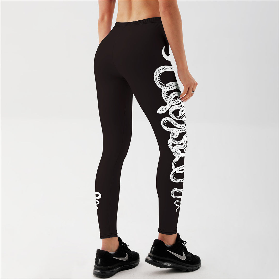 "Black yoga leggings with white coiled snake artwork wrapping leg, mid waist stretchy sportswear for studio sessions"