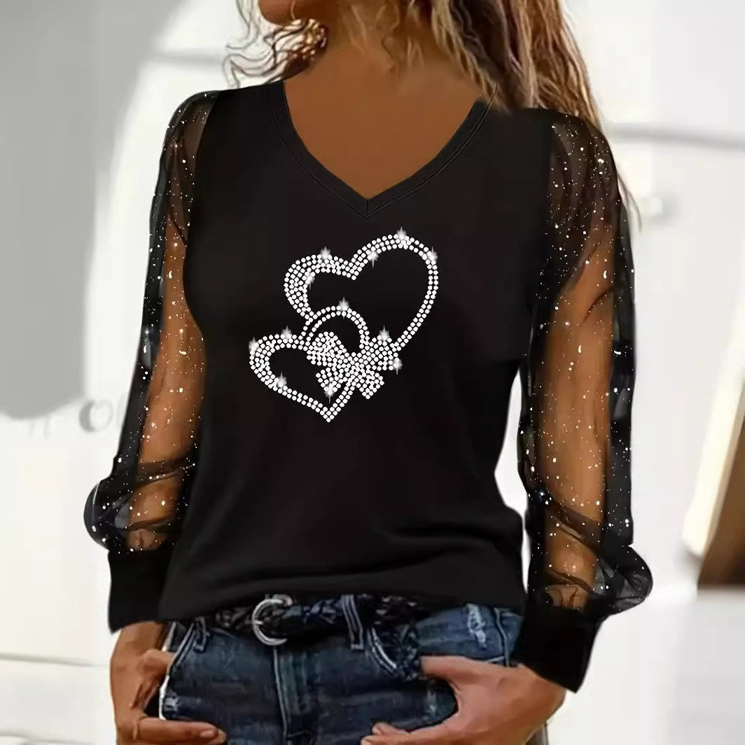 Original supplier photo of the black V-neck top with intertwined outline hearts and sheer dotted sleeves