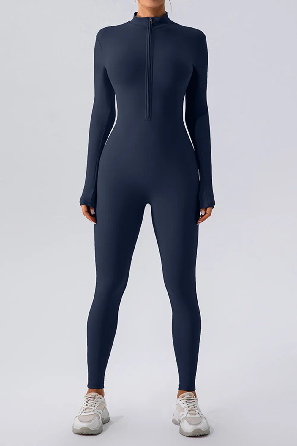 half zip mock neck jumpsuit back view showing fitted hips and full length legs for confident studio to street wear
