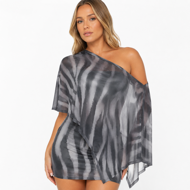 Gray animal print two piece set shown in a closer studio view highlighting the asymmetric overlay, print, seams and fitted base.