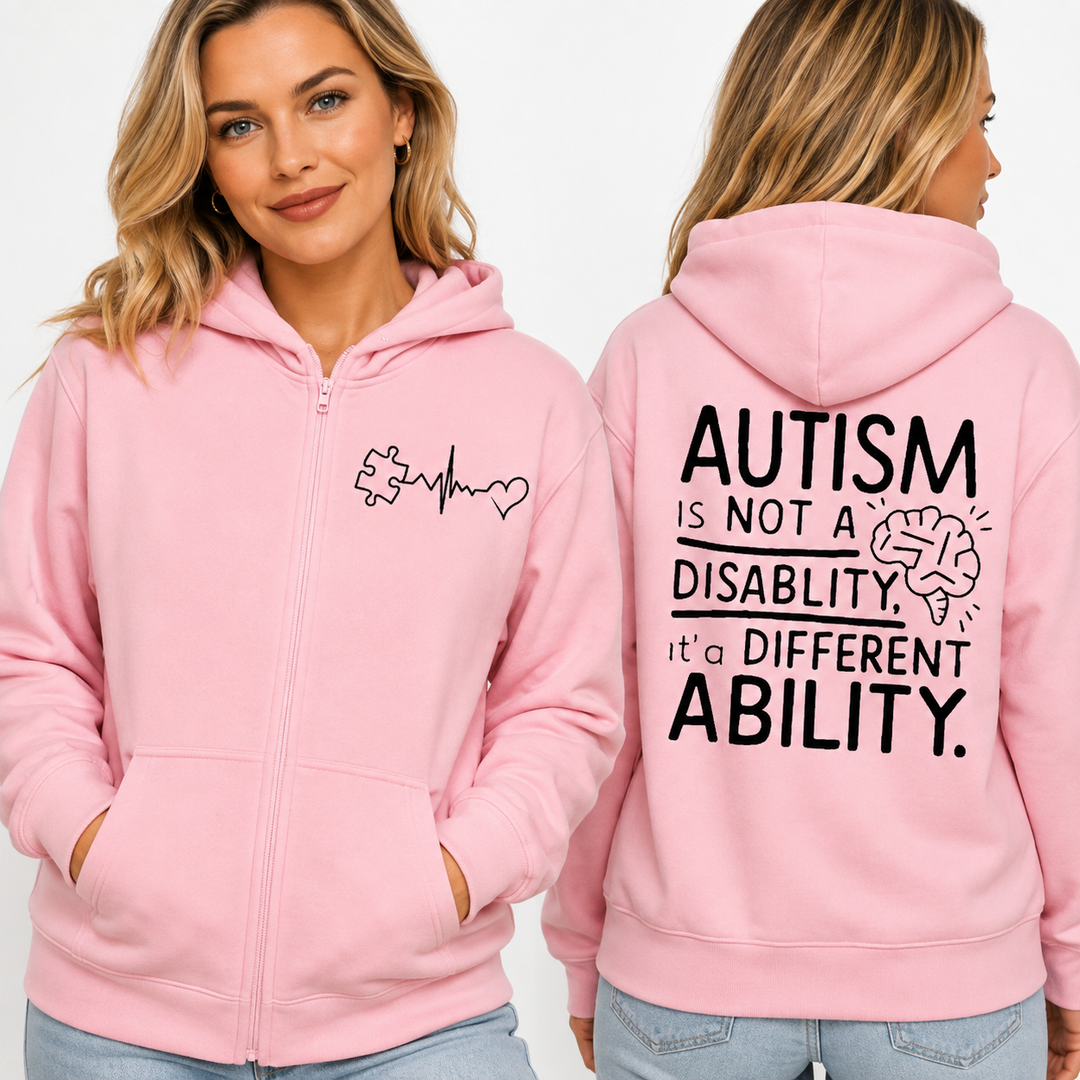 Autism awareness hoodie in Soft Pink shown in a closer adult model view highlighting the front zip, pockets and printed graphics.
