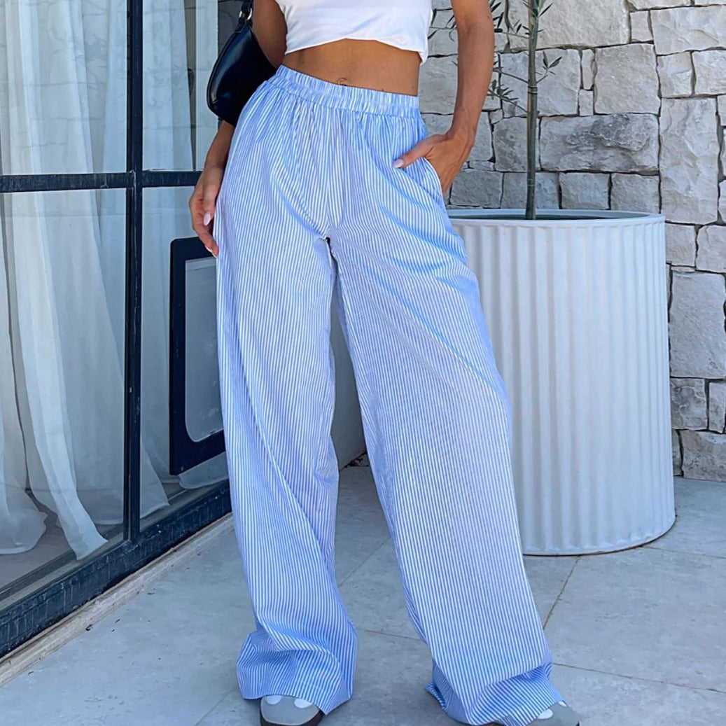 High waisted striped wide leg pants for women in Y2K summer styling showing the elastic waist and a loose trouser silhouette.