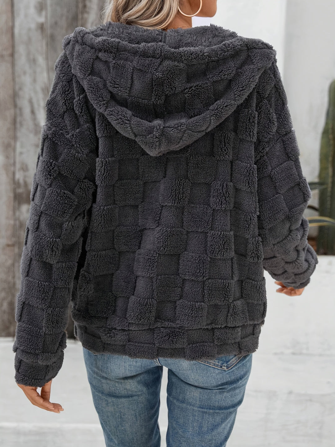 Plush hooded zip-up jacket on a professional model in natural side pose showing regular fit, long sleeves and casual styling.