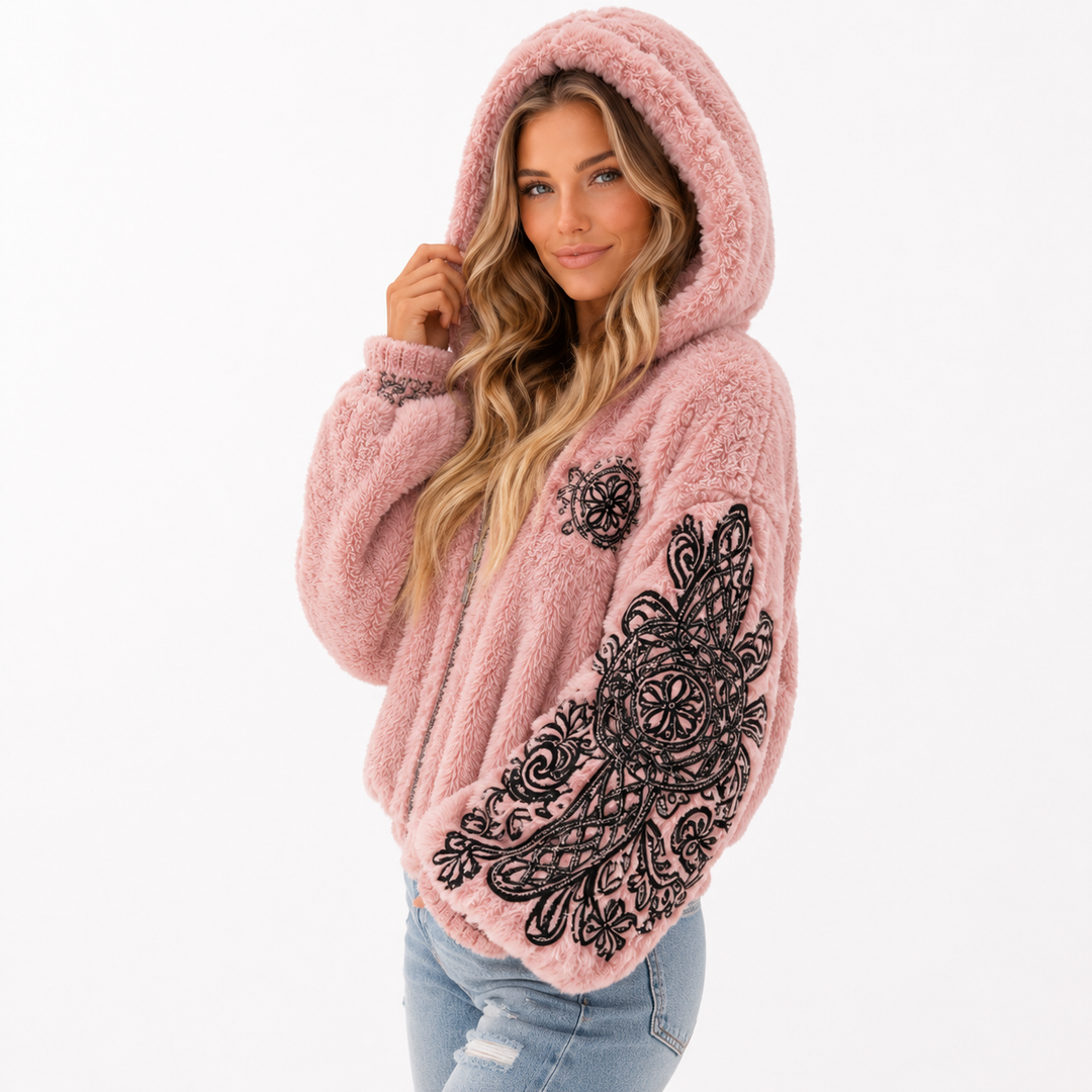 Pink hooded jacket styled for snow days with casual jeans and layered jewelry