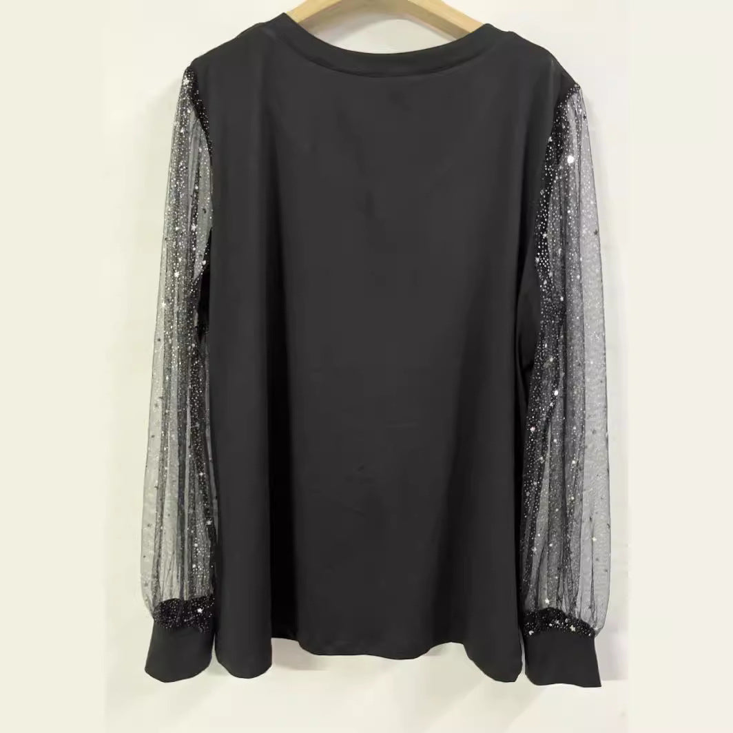 Original supplier back view of the black top with a plain back, sheer dotted sleeves and opaque cuffs
