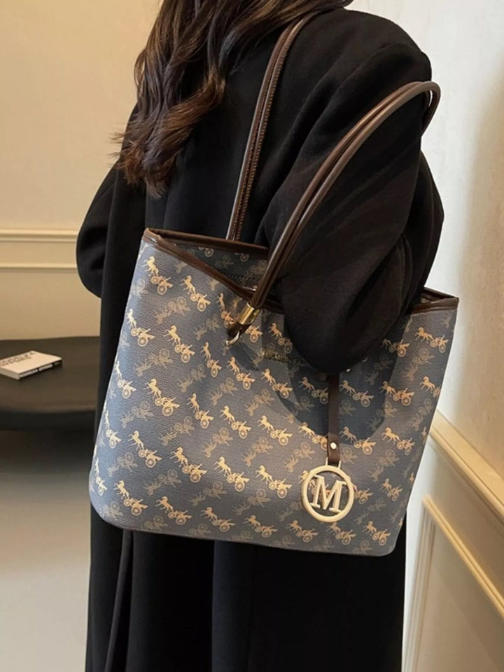 Person holding a patterned handbag with a visible brand logo.