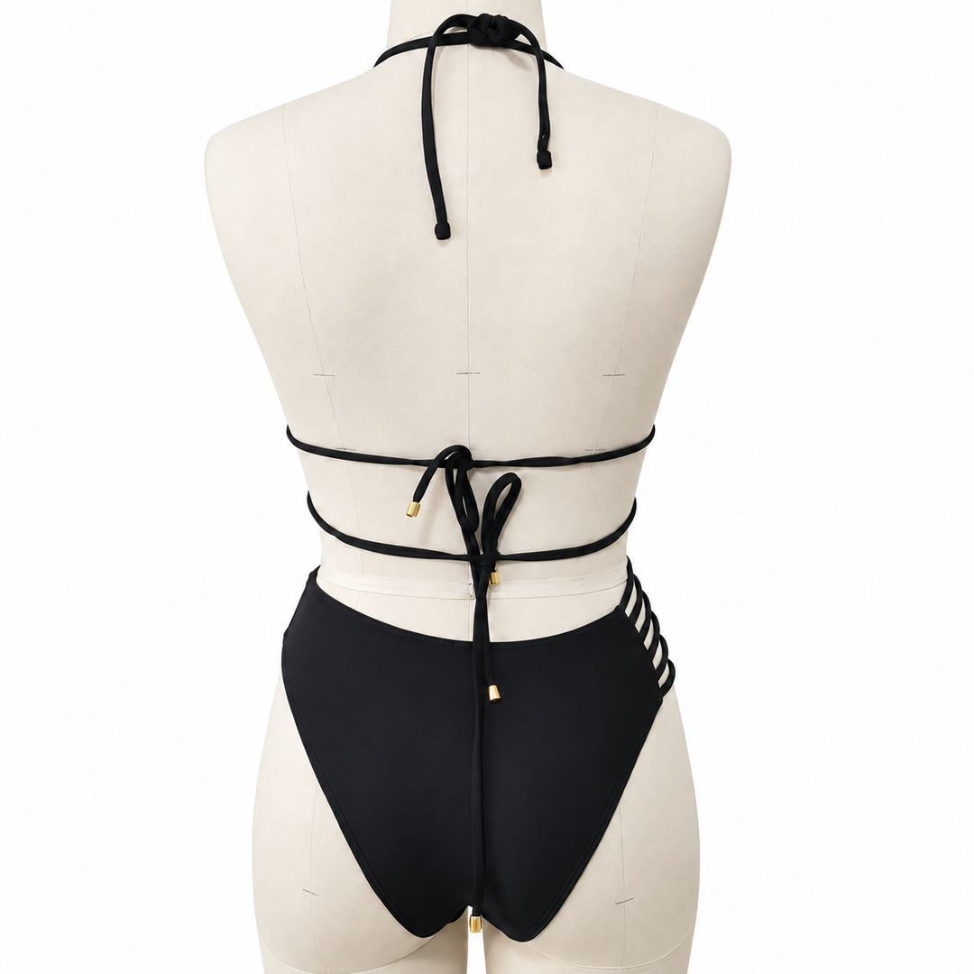 Black bikini back view on a fabric display mannequin against white, showing the halter ties, back knots and matching bottoms.