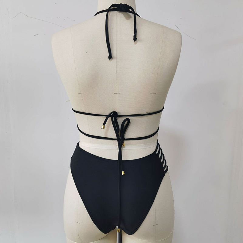 Black bikini back view on a supplier mannequin showing neck ties, back ties, metal-tipped cords and rear of matching bottoms.