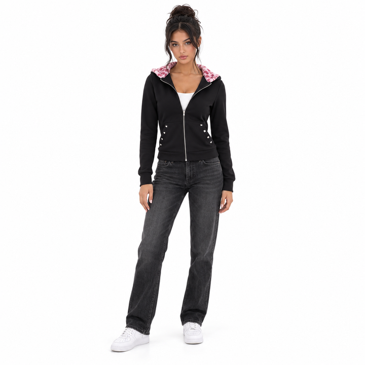 Black slim fit hoodie on a full-length model, showing silver zip, studded pockets and pink hood lining on a white background.