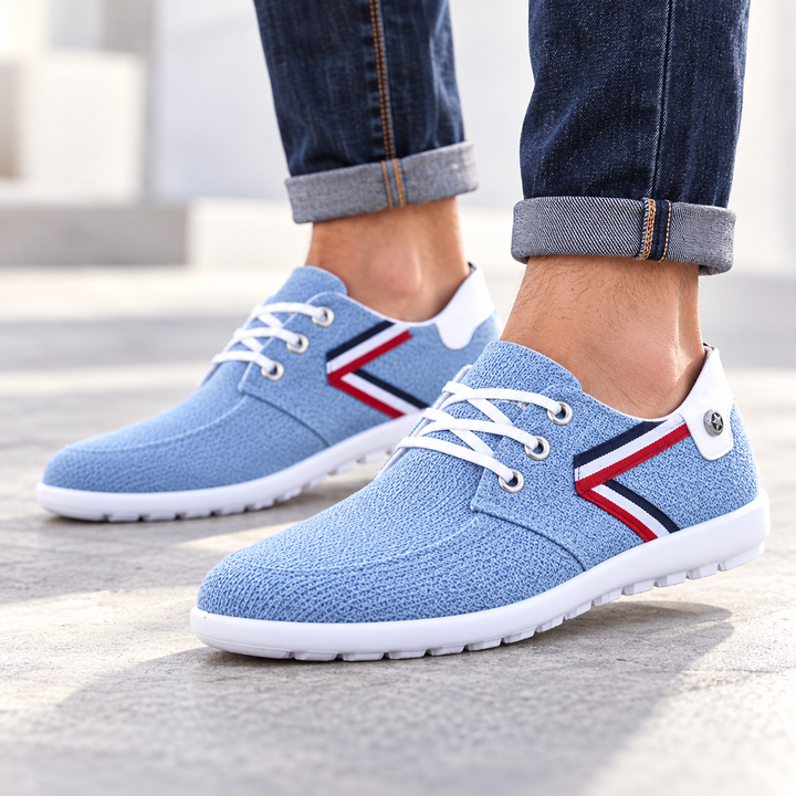 Blue lace-up shoe with chevron side accent and white outsole on a clean white background