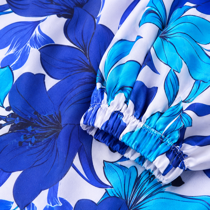 Close-up of blue floral fabric, gathered sleeve cuff and stitching detail