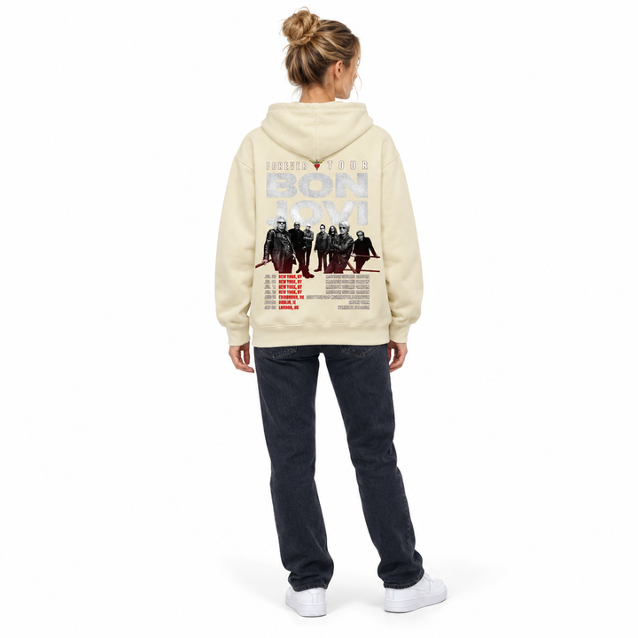 Cream graphic pullover hoodie viewed from behind on a full-length female model, showing the band artwork and tour date print.
