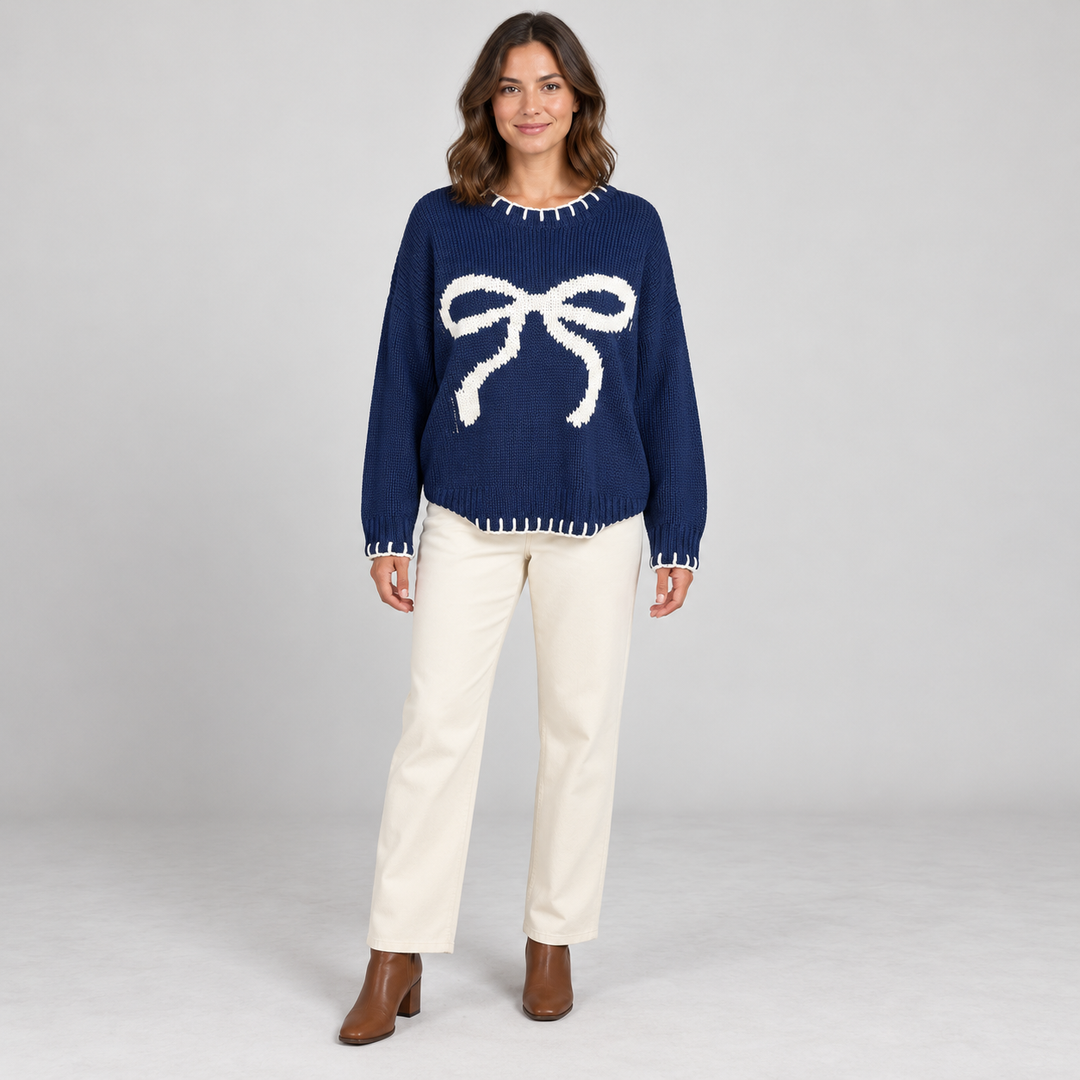 Full-body model wearing navy bow-pattern sweater.