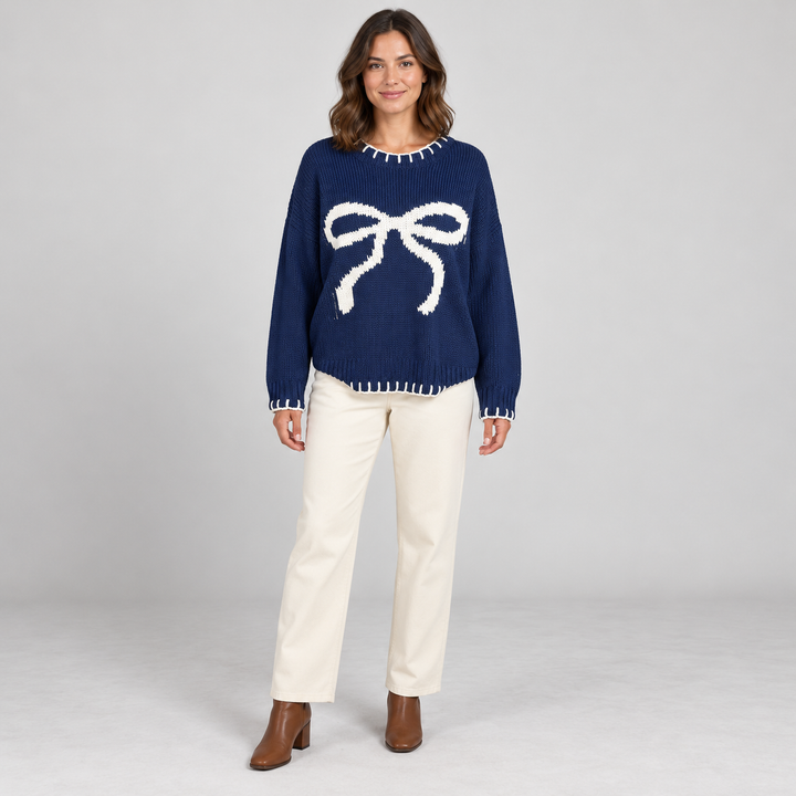 Full-body model wearing navy bow-pattern sweater.