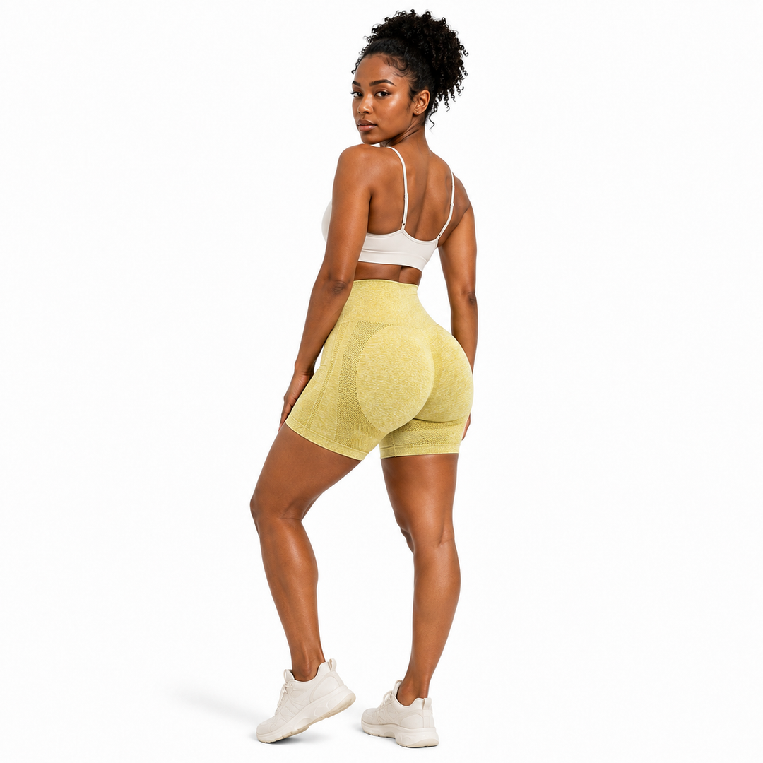 Yellow butt lifting yoga shorts rear three-quarter view on female model