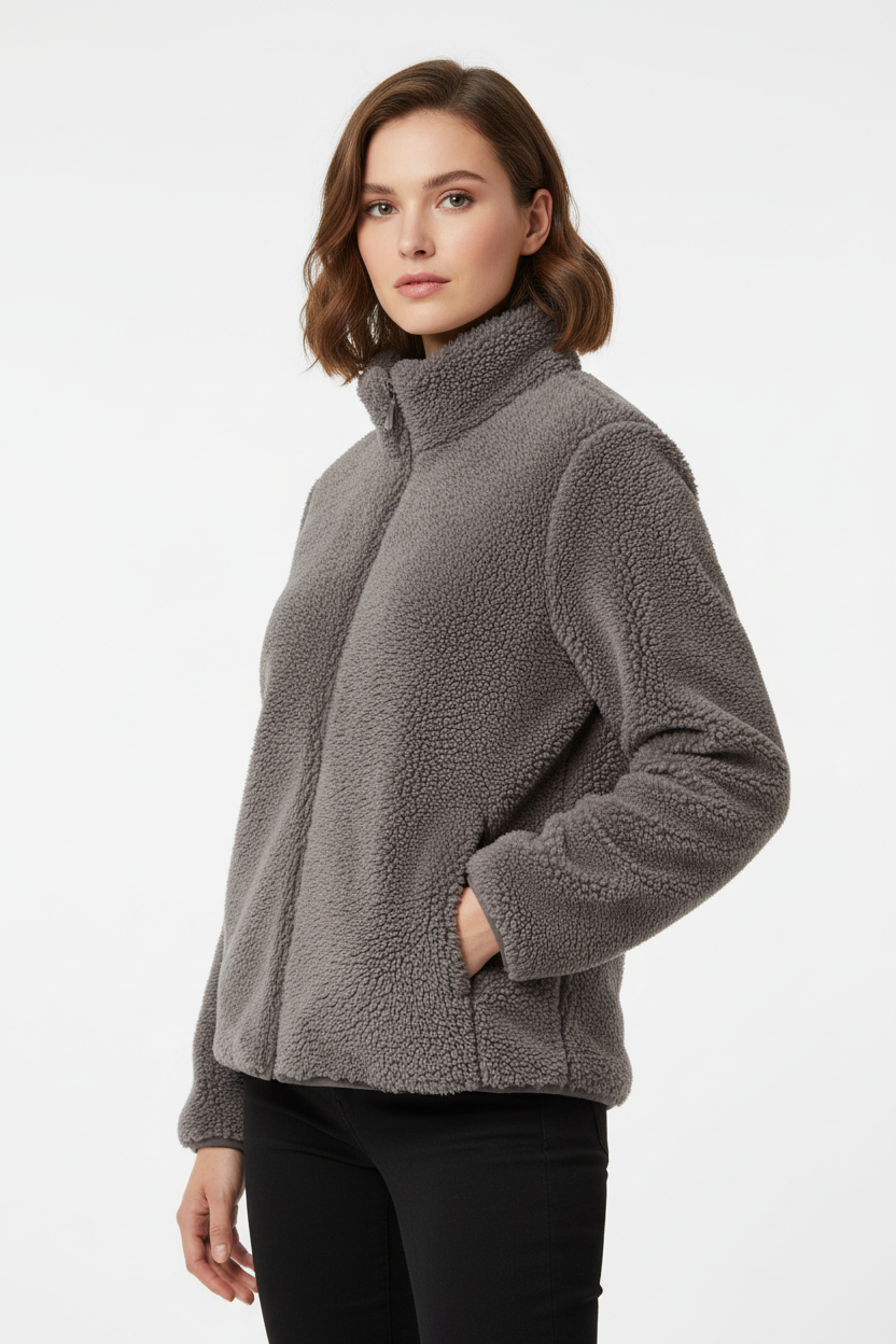 Woman wearing a gray fleece jacket on a white background