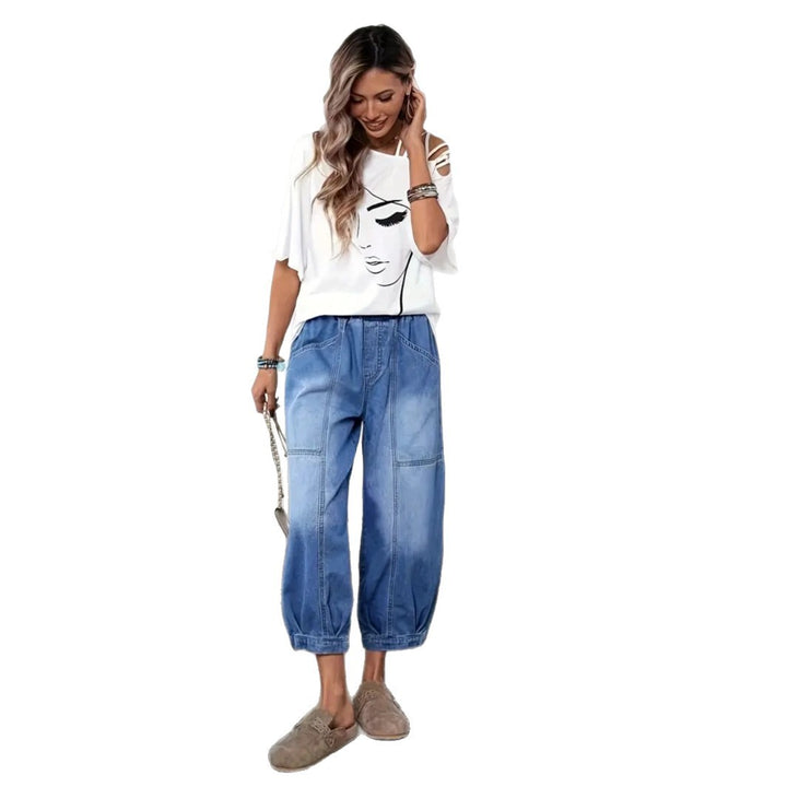 Front view of relaxed denim pants with mid-calf cropped length and soft drape