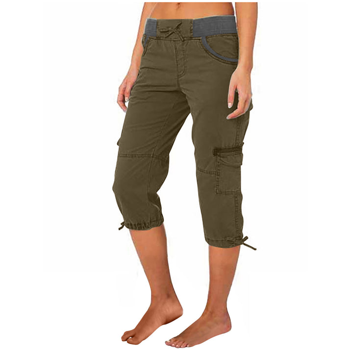 Olive green capri pants worn by a person on a white background