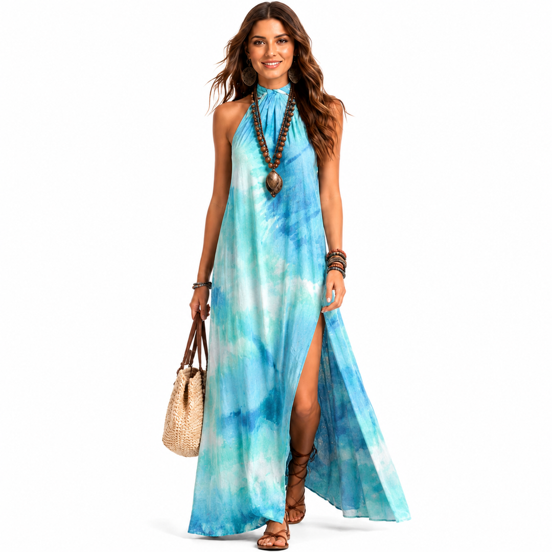 Blue patterned halter dress showing long skirt movement, side slit styling and effortless vacation-ready outfit idea for her.