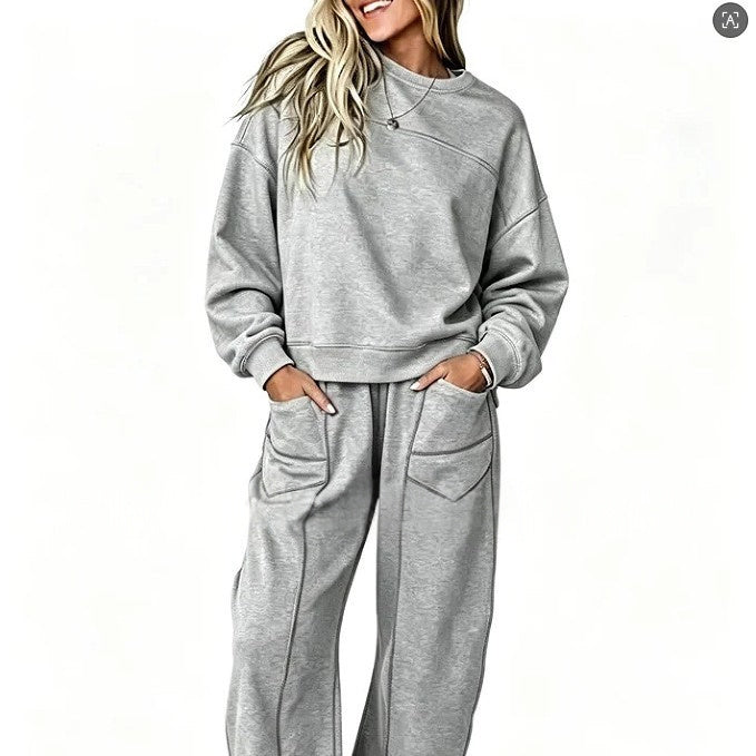 Original close view of the gray sweatshirt set showing the chest seam, sleeve cuffs and trouser pockets