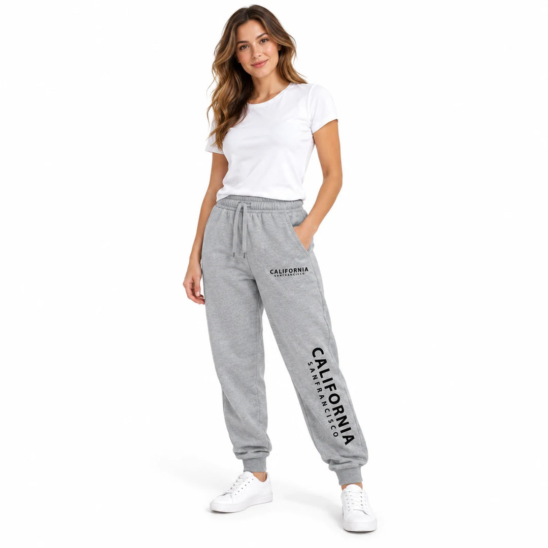 Heather gray California sweatpants worn by a female model with a white T-shirt and white sneakers, in a white studio setting.