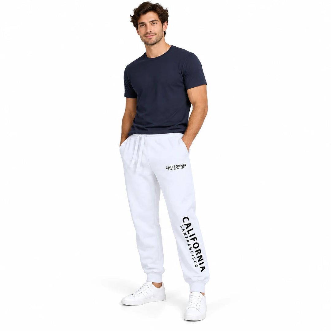 White California sweatpants worn by a male model with a navy T-shirt and white sneakers, shown full length in a white studio.