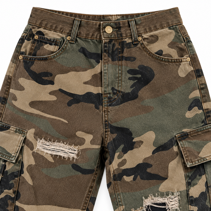 Camouflage cargo pants close-up showing waistband, front pockets and distressed finish