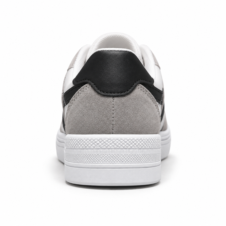 Back view of black striped canvas shoes showing the black heel tab, gray rear overlay and white textured sole.