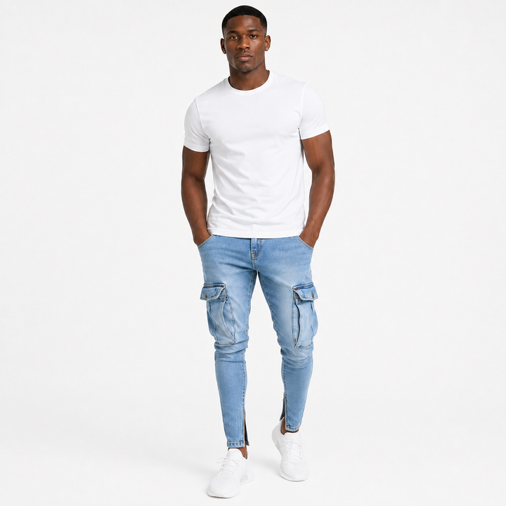 Minimal studio lifestyle image of washed light blue cargo jeans for men on an adult male model with tapered fit and cargo pockets.