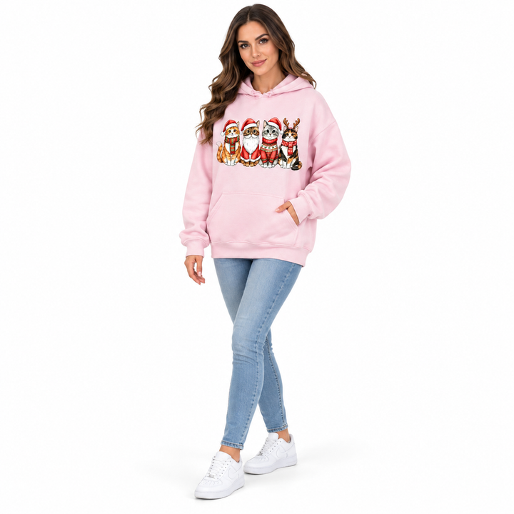 Three-quarter view of a woman wearing a pale pink cat-print hoodie with blue jeans.