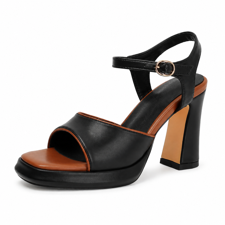 Chunky heel sandals in black with square open toe, ankle buckle, tan footbed and platform sole on clean white studio setting.