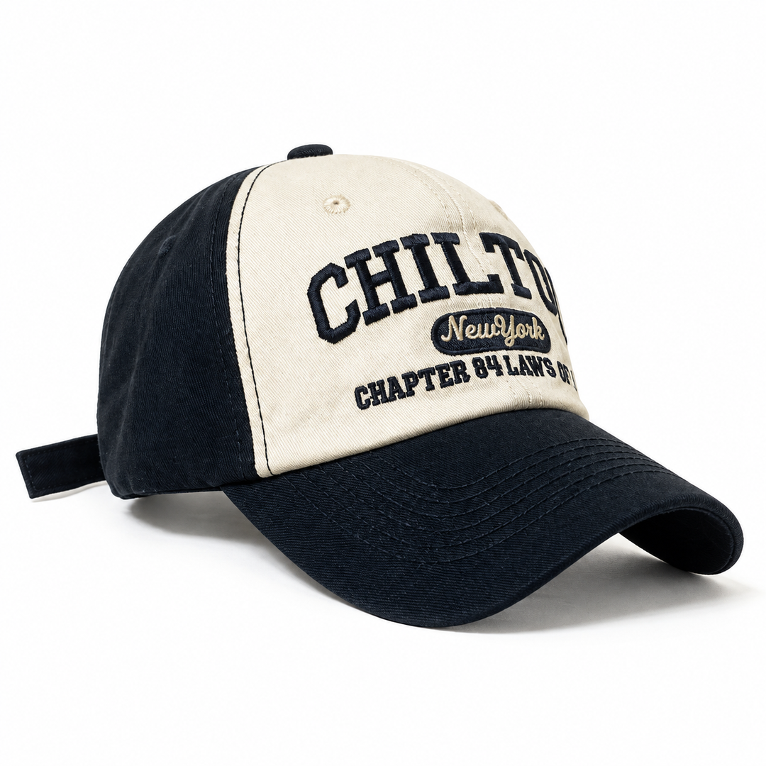 Color block baseball cap in Black with cream embroidered front panels, a curved brim and a back strap, photographed on white.