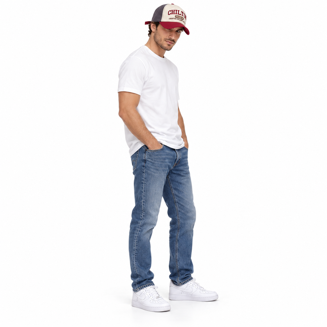 Full-length side view of a male model wearing the Gray and Wine Red embroidered cap with a white T-shirt, jeans and sneakers.