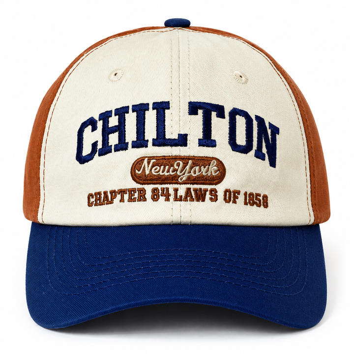 Close-up of the Light Brown and Navy Blue cap showing CHILTON embroidery, oval script detail and stitched cream front panels.