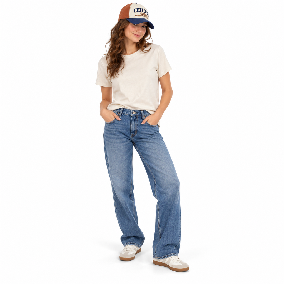 Full-length female model wearing the Light Brown and Navy Blue embroidered cap with a cream T-shirt, jeans and white sneakers