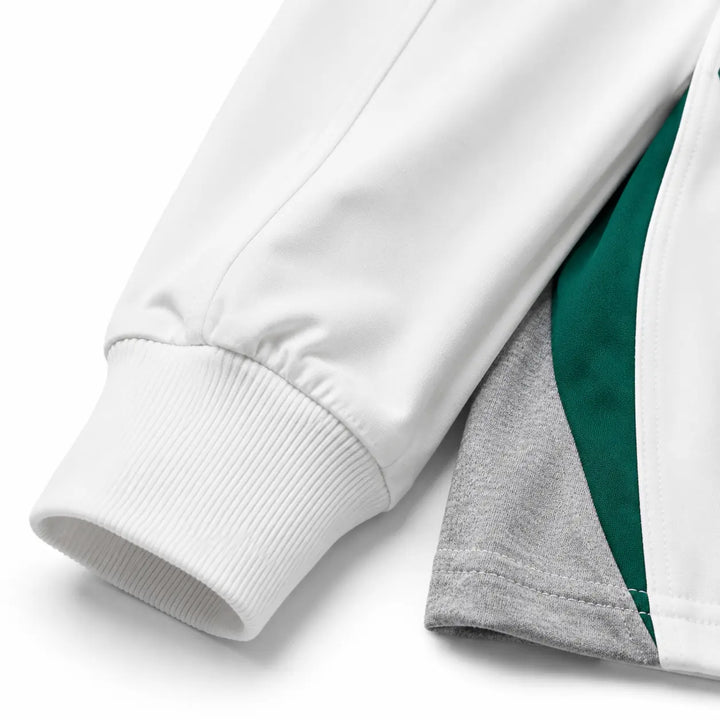 Close-up of White sweatshirt ribbed cuff, sleeve seam and color block panel construction on white background.