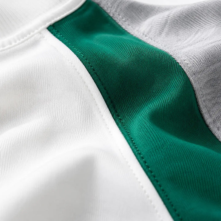 Macro view of White, green and gray sweatshirt fabric with clean stitching and slight-stretch material texture.